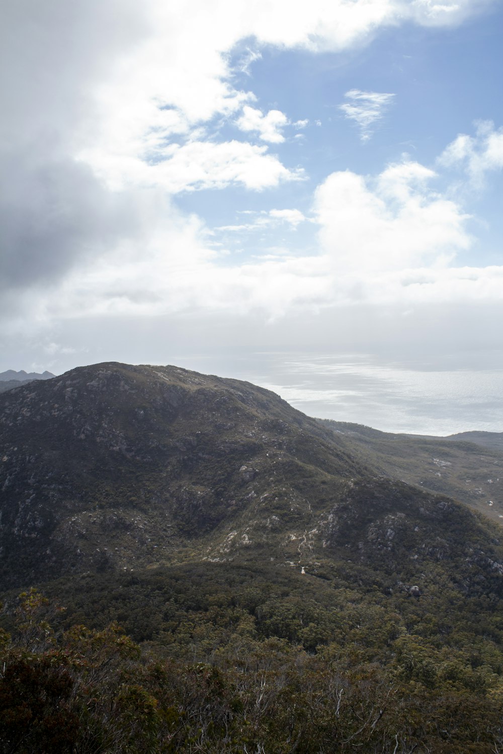 a view of a mountain with a cloudy sky