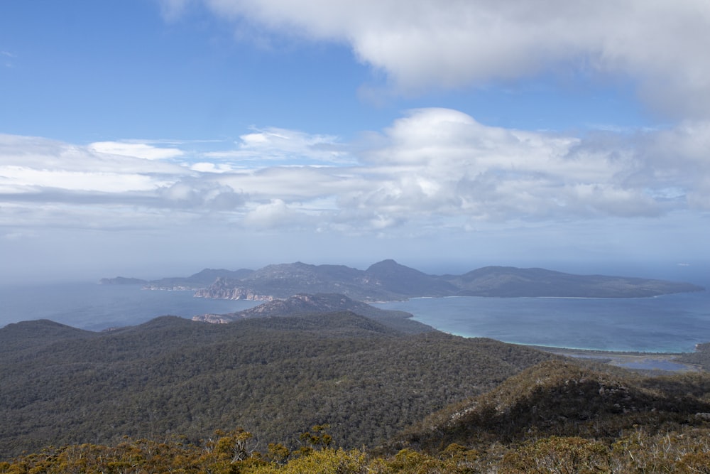 a view of a mountain range with a body of water in the distance