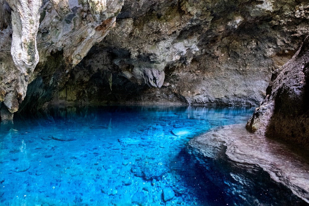 a blue pool in the middle of a cave