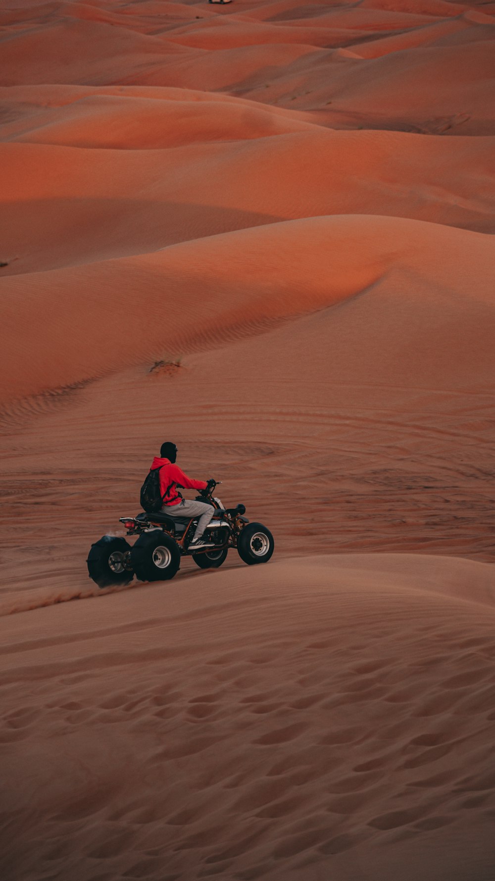 a person riding a four wheeler in the desert