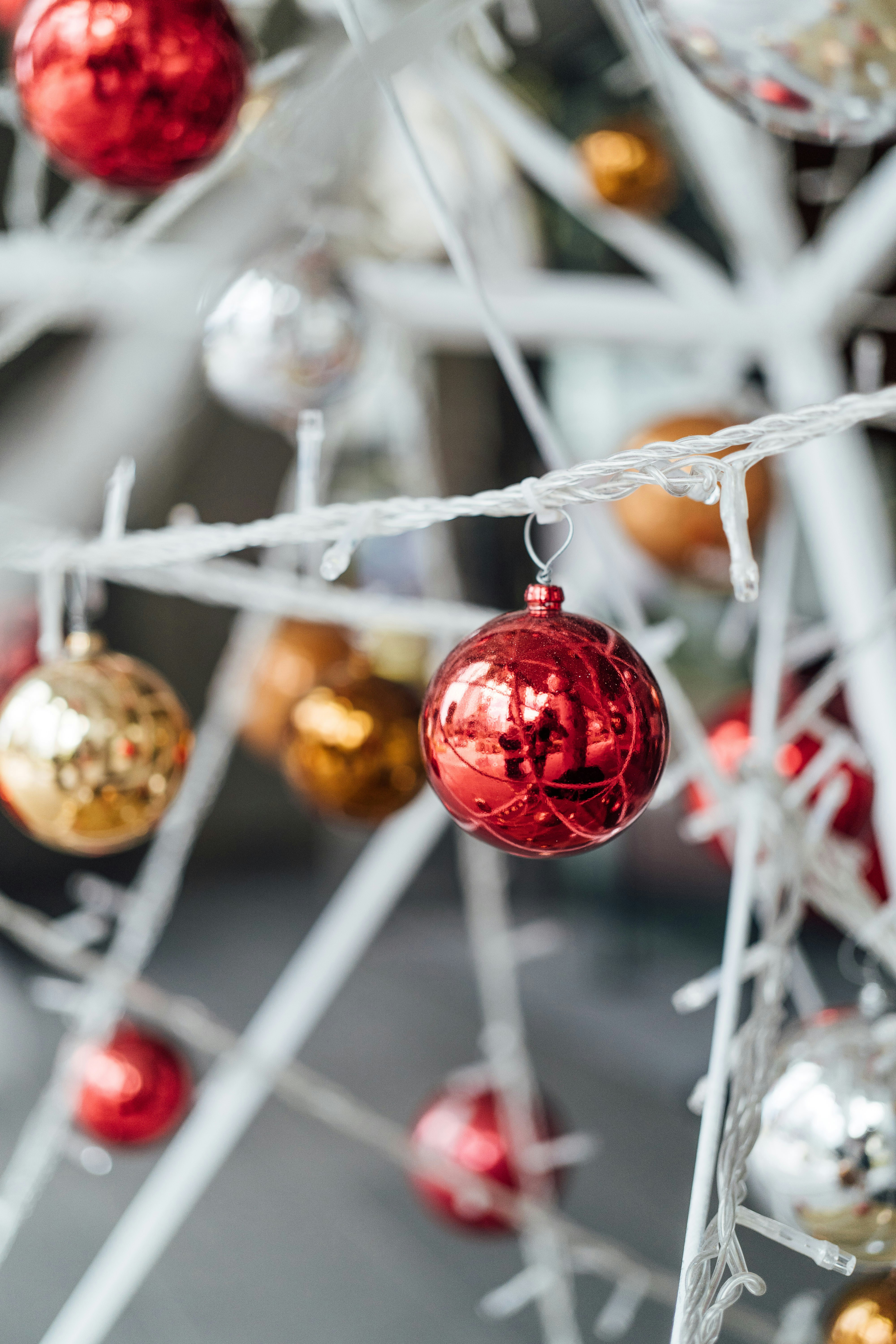 a close up of a christmas tree with red and gold ornaments