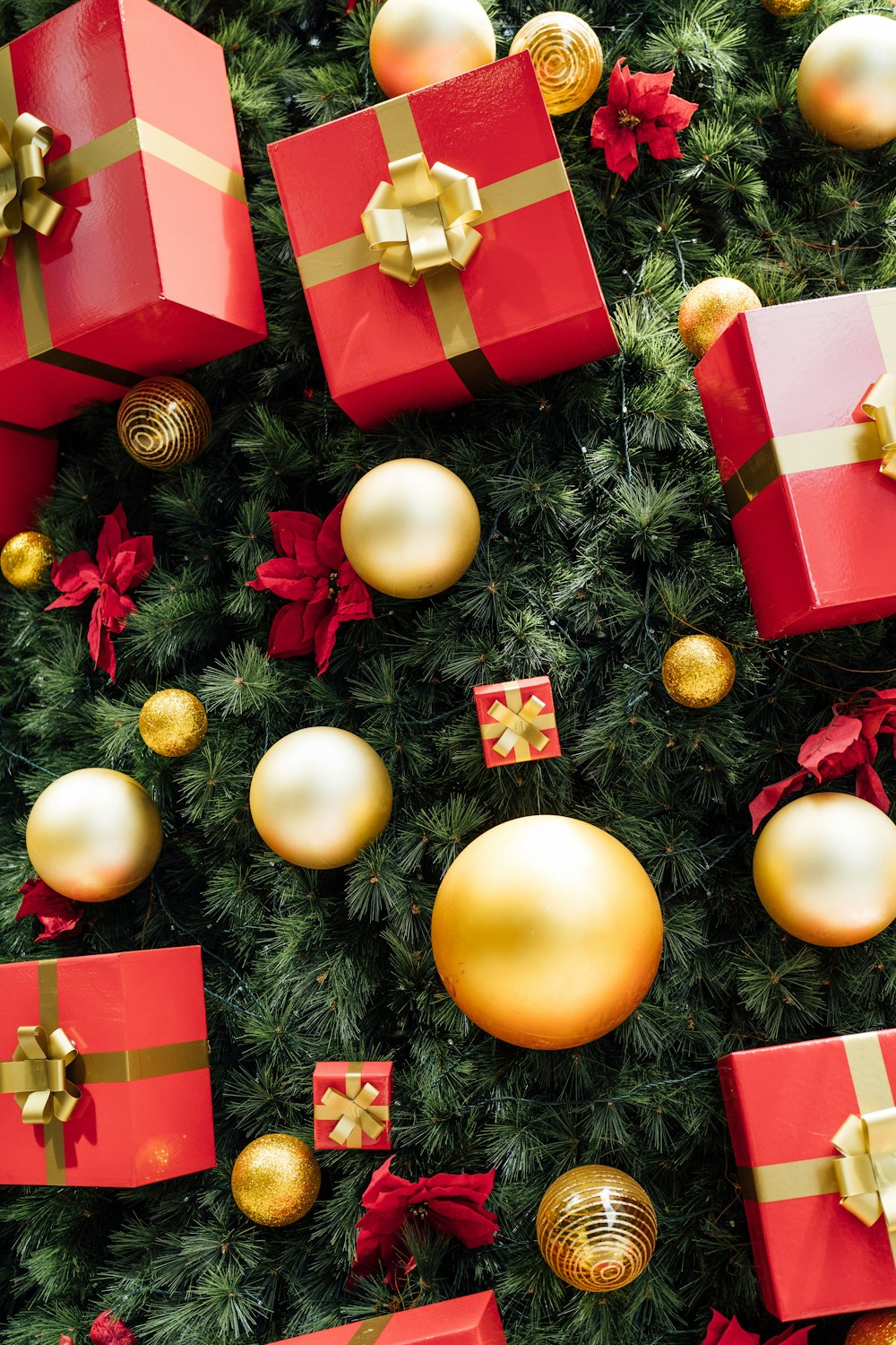 a christmas tree covered in lots of red and gold presents