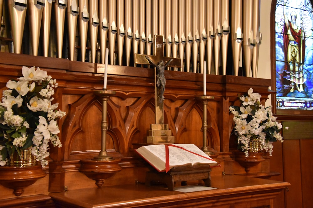 a wooden alter with flowers and a book on it