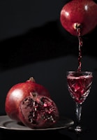 a pomegranate is being poured into a glass
