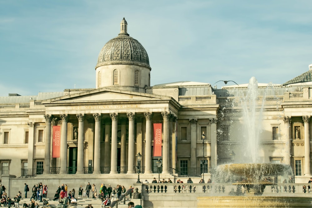 a large building with a fountain in front of it