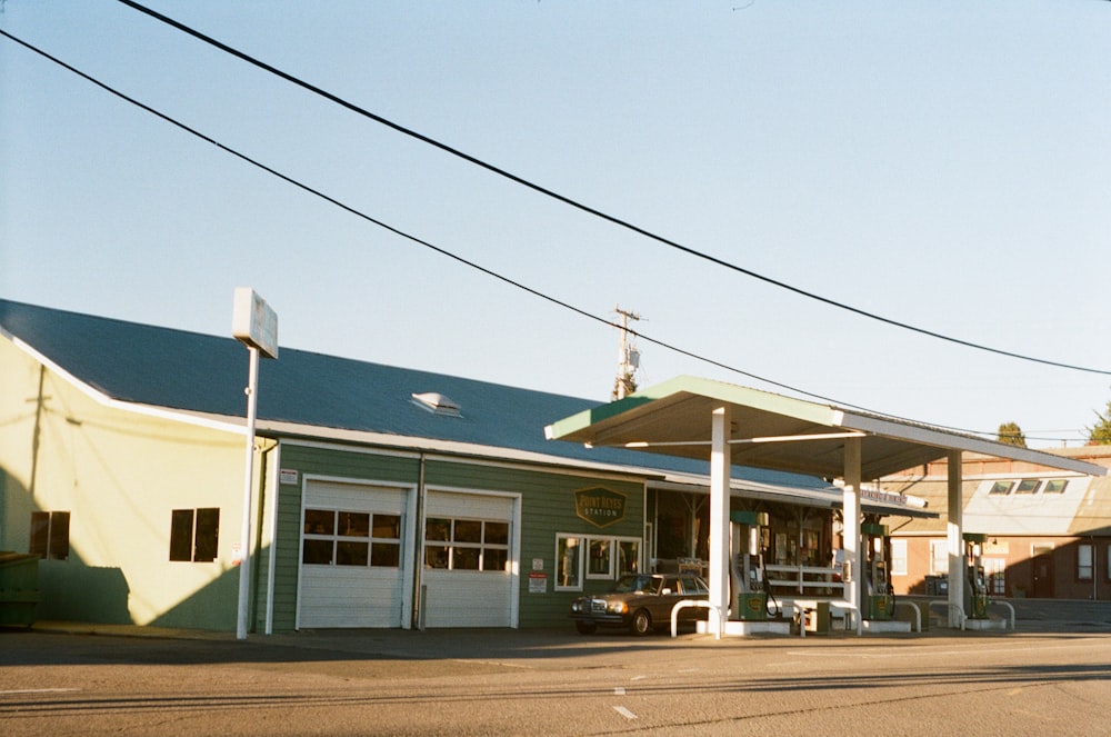 a gas station with a car parked in front of it