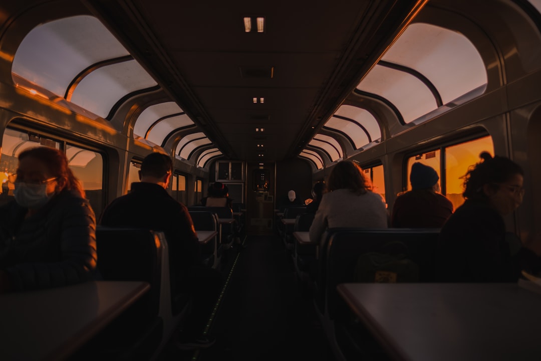 a group of people sitting on a train next to each other, Taking the Coast Starlight at sunset.