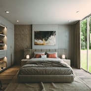 a bedroom with a large bed and a painting on the wall