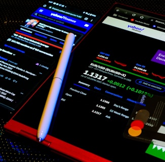 a cell phone with a pen on top of it