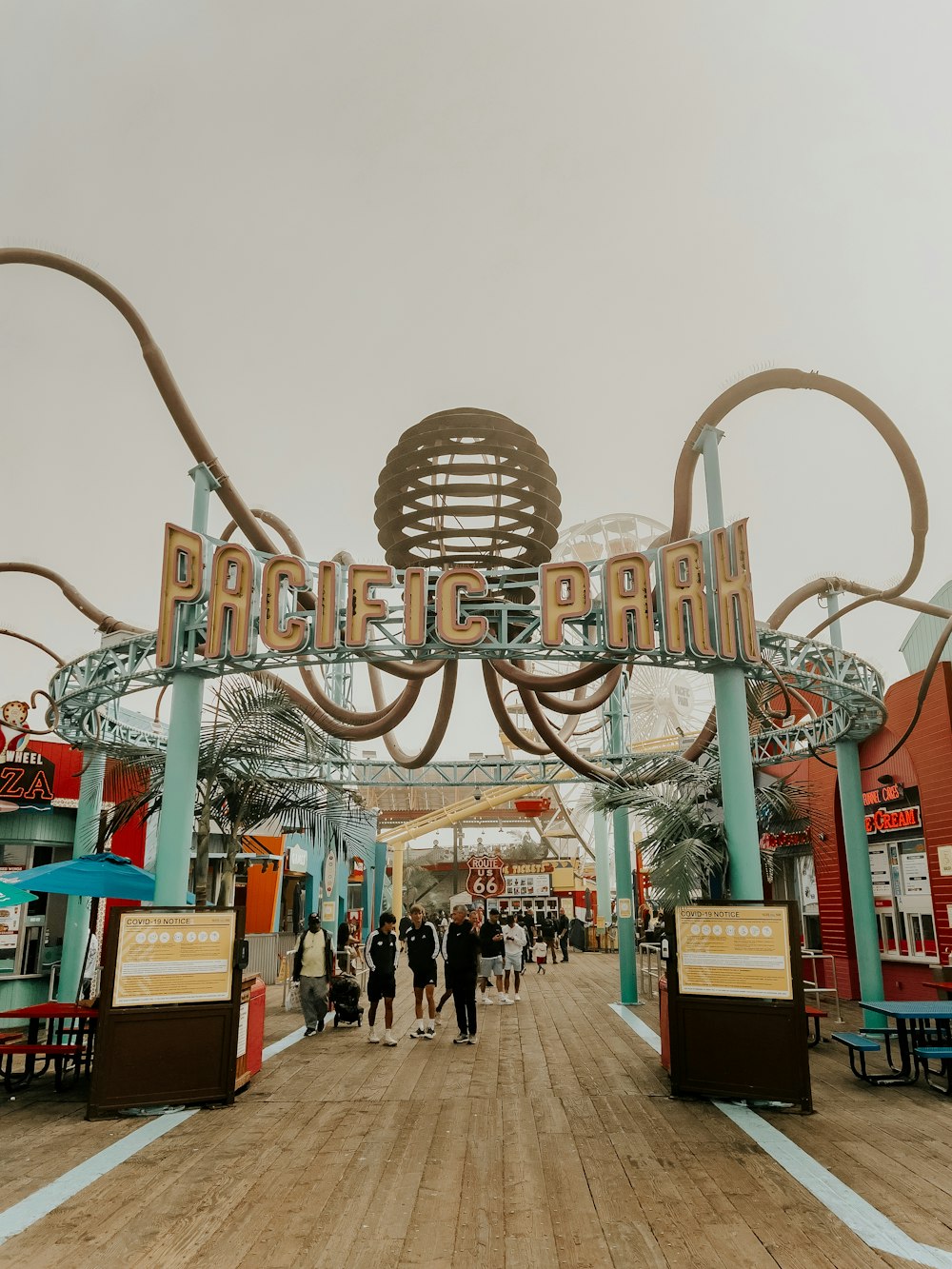 the entrance to pacific park with people walking around