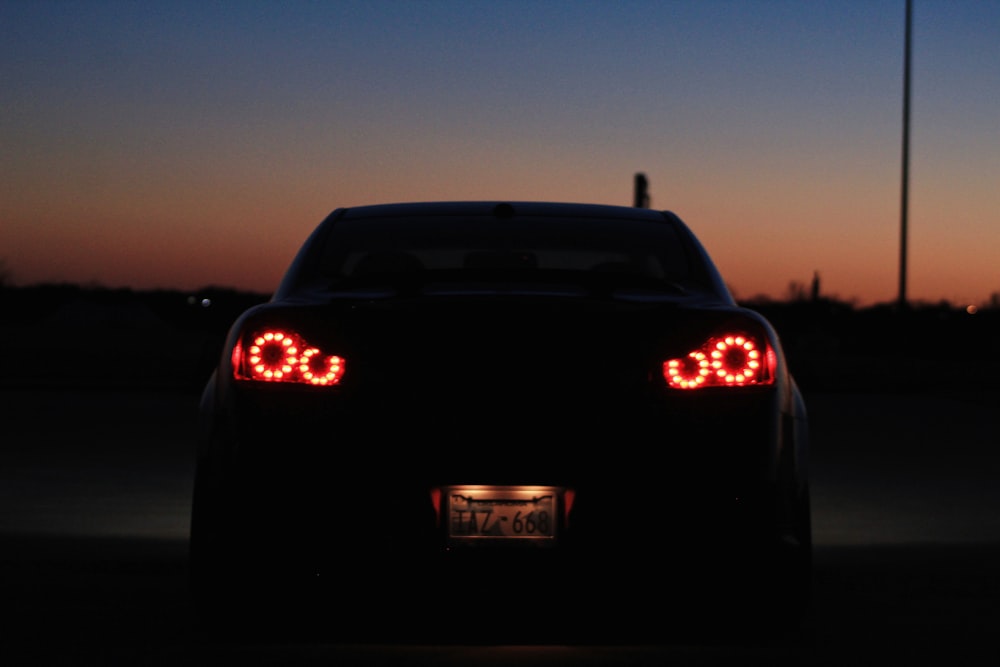 the tail lights of a car at dusk