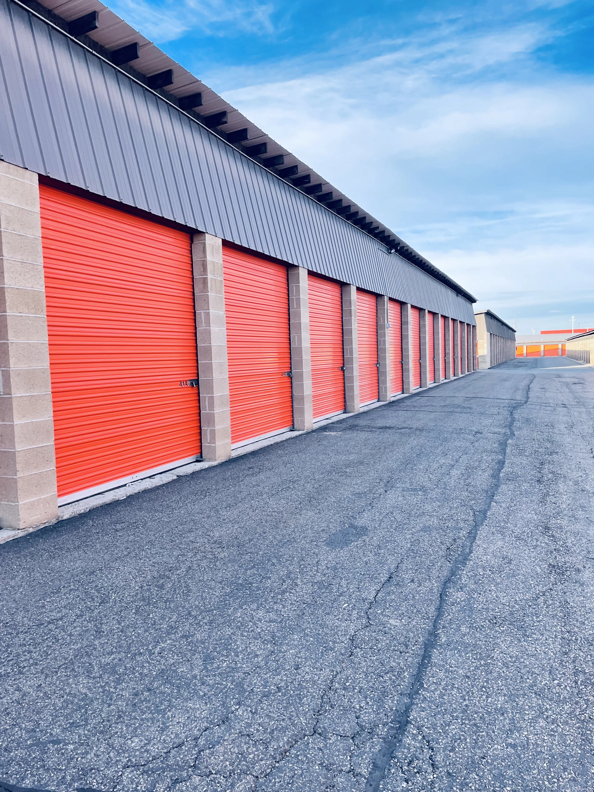 a row of storage units with red doors