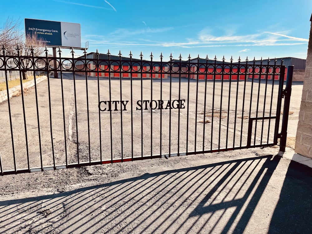 a gate with a sign that says city storage