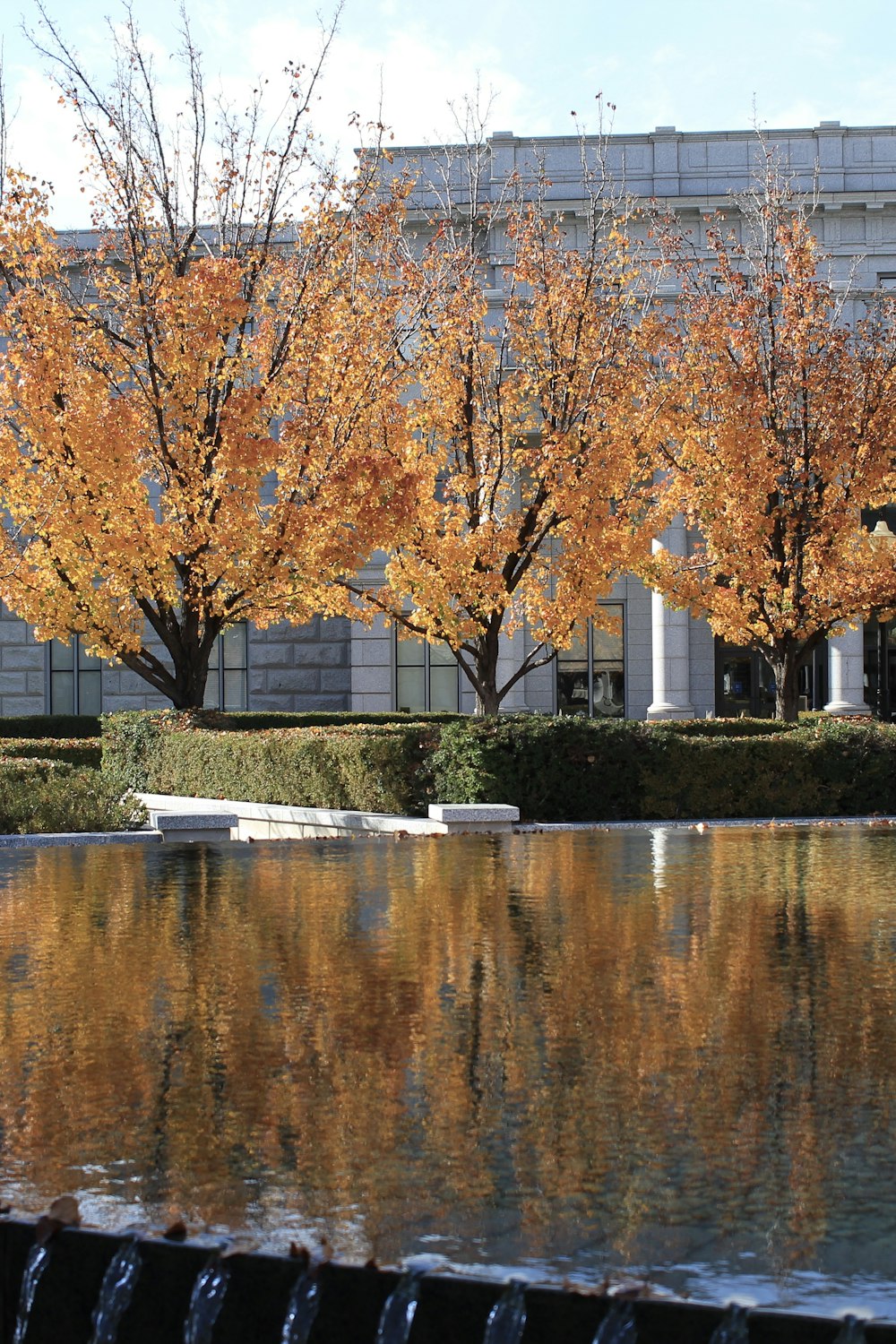 a large building with a fountain in front of it