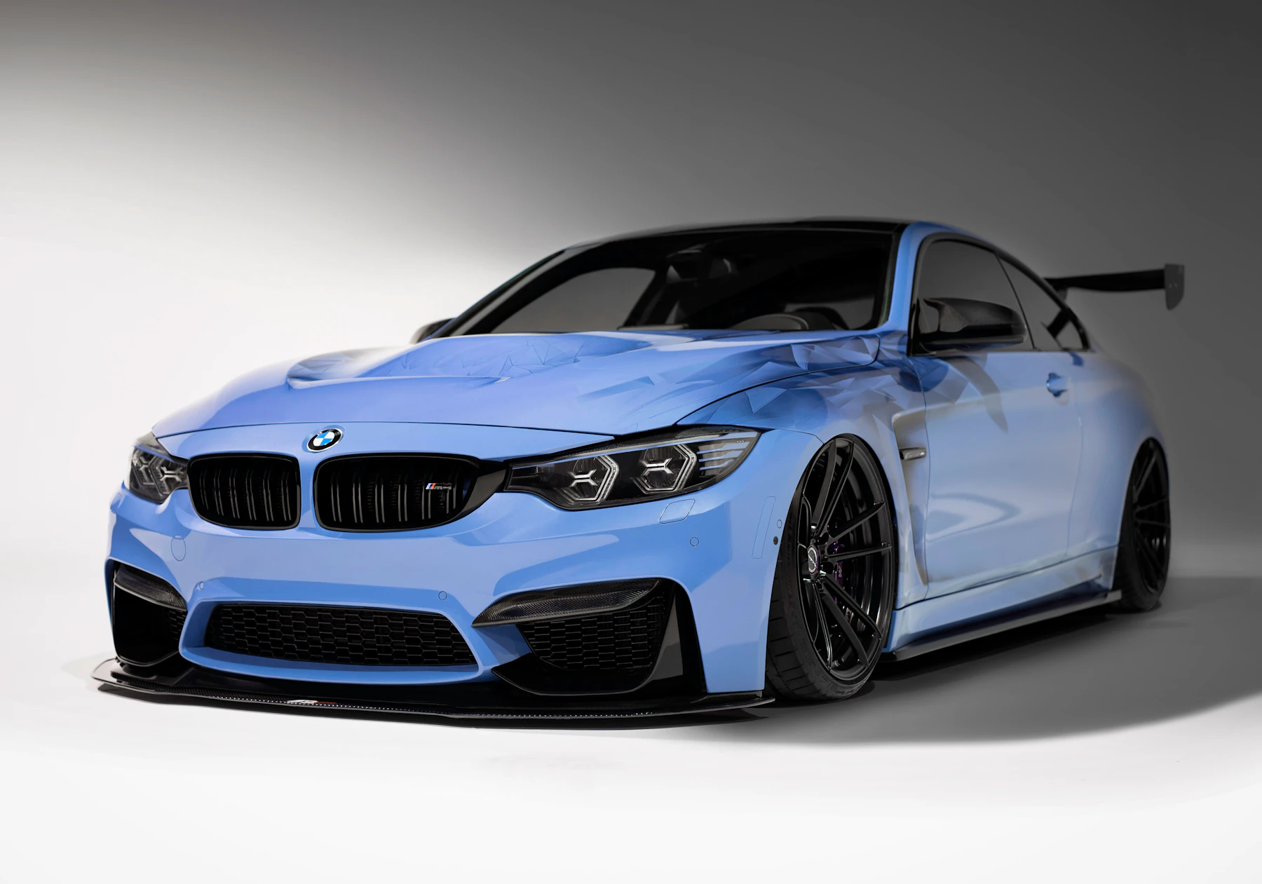 Light blue sports coupé photographed in a grey studio
