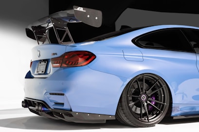 the rear end of a blue sports car