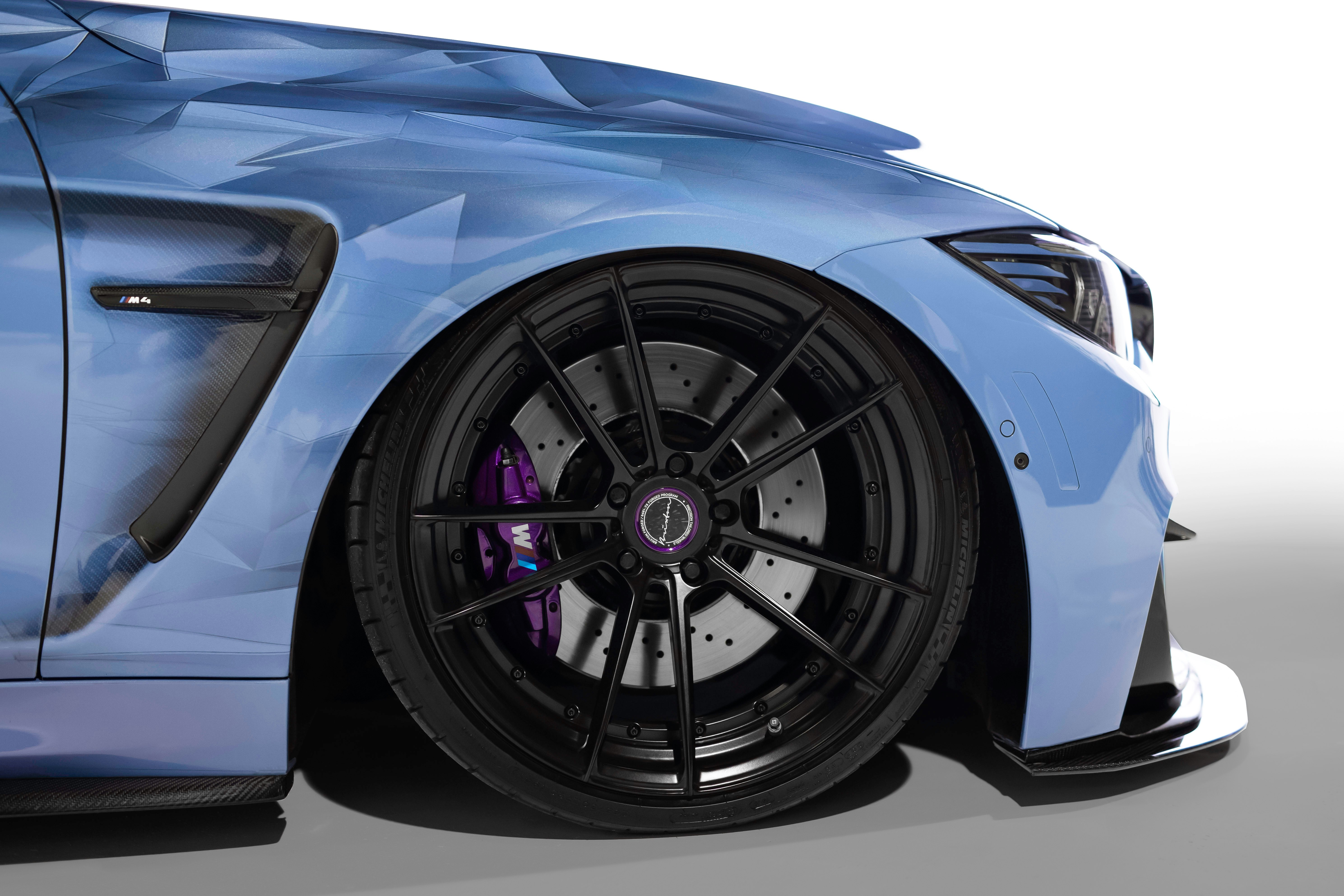 a close up of the front of a blue sports car