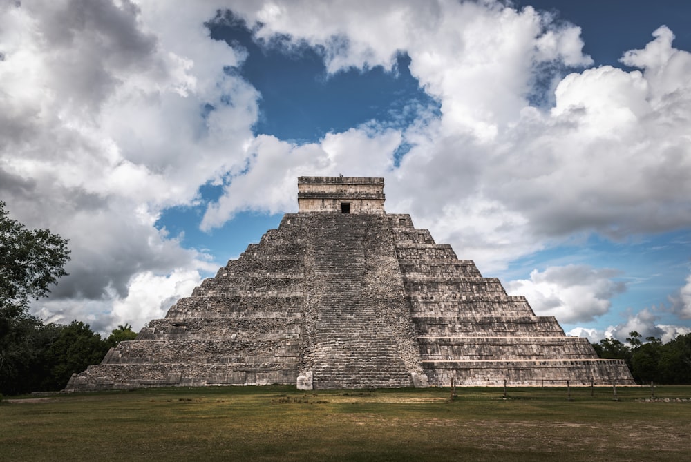 a large pyramid in the middle of a field