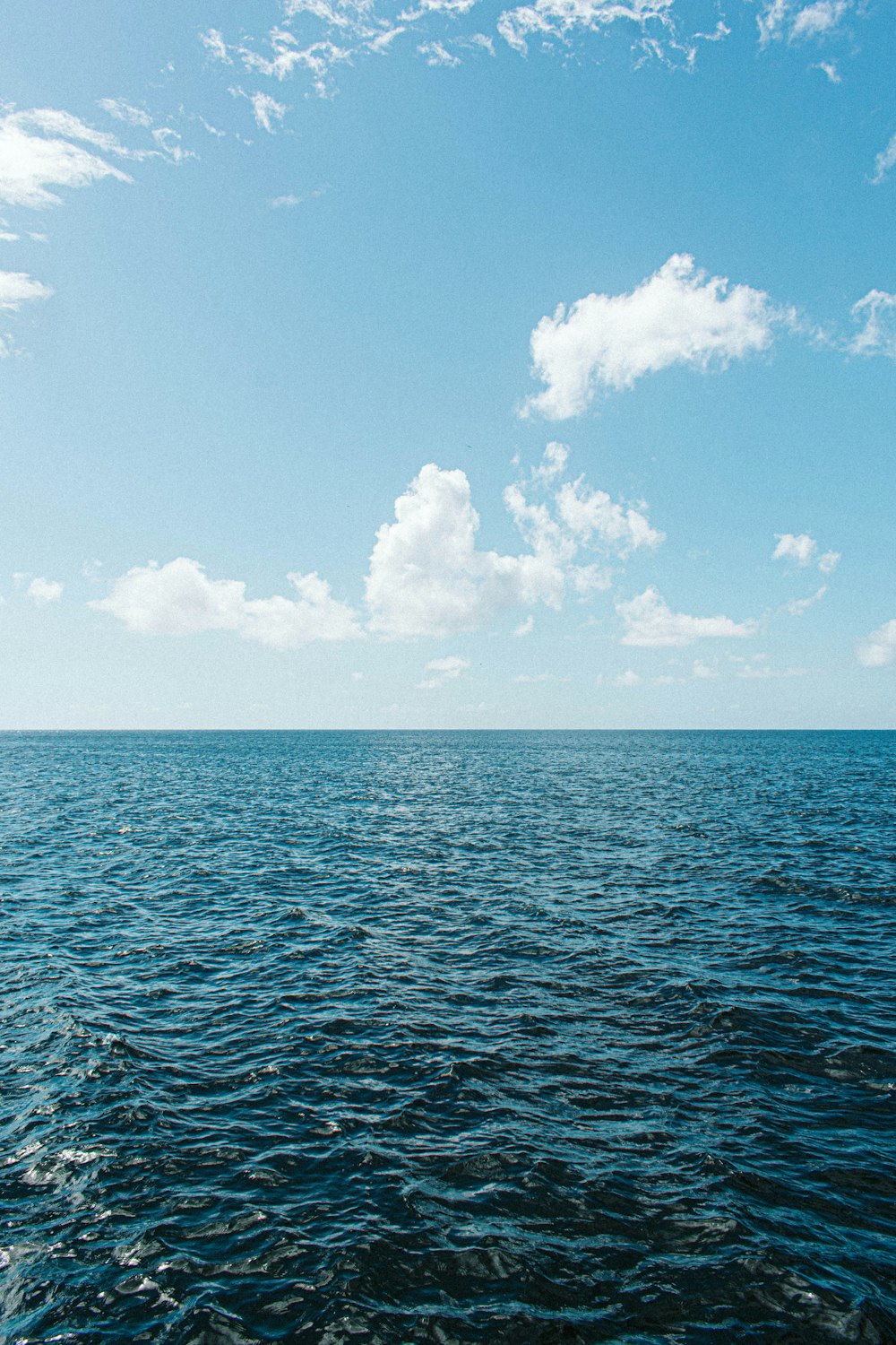 a large body of water under a blue sky