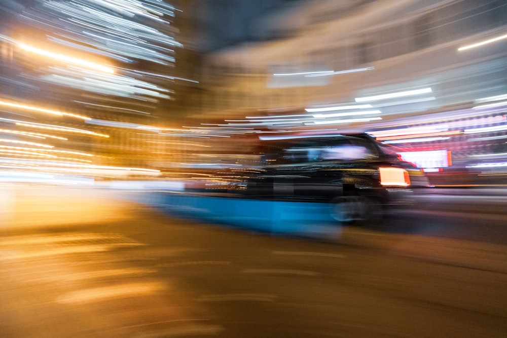 a blurry photo of a truck driving down a street