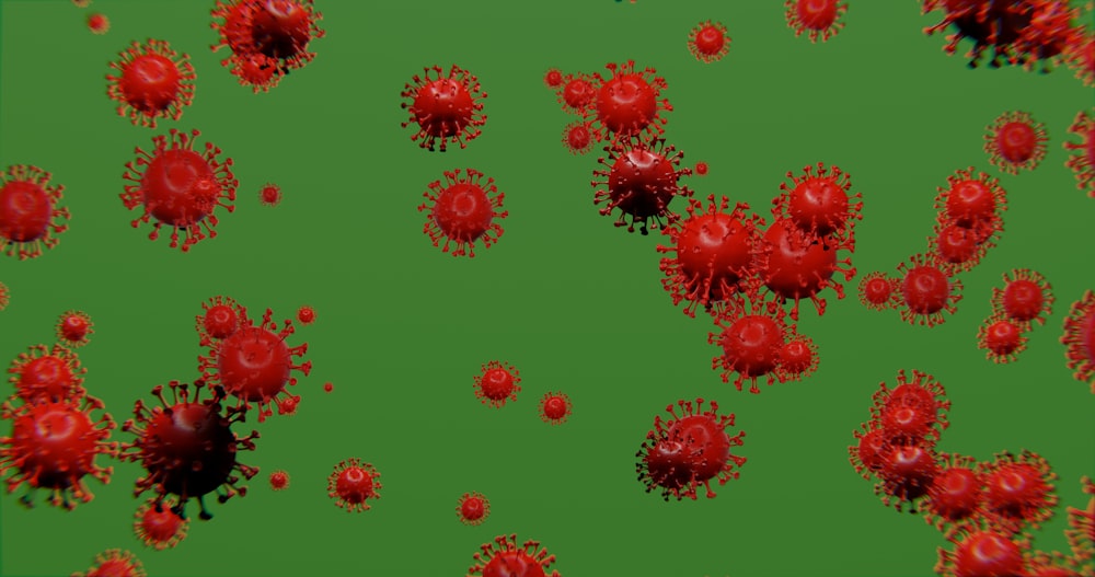 a group of red balls of blood on a green background