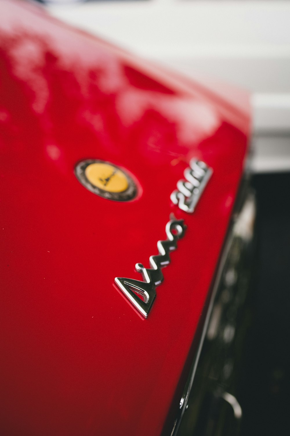 a close up of the emblem on a red car