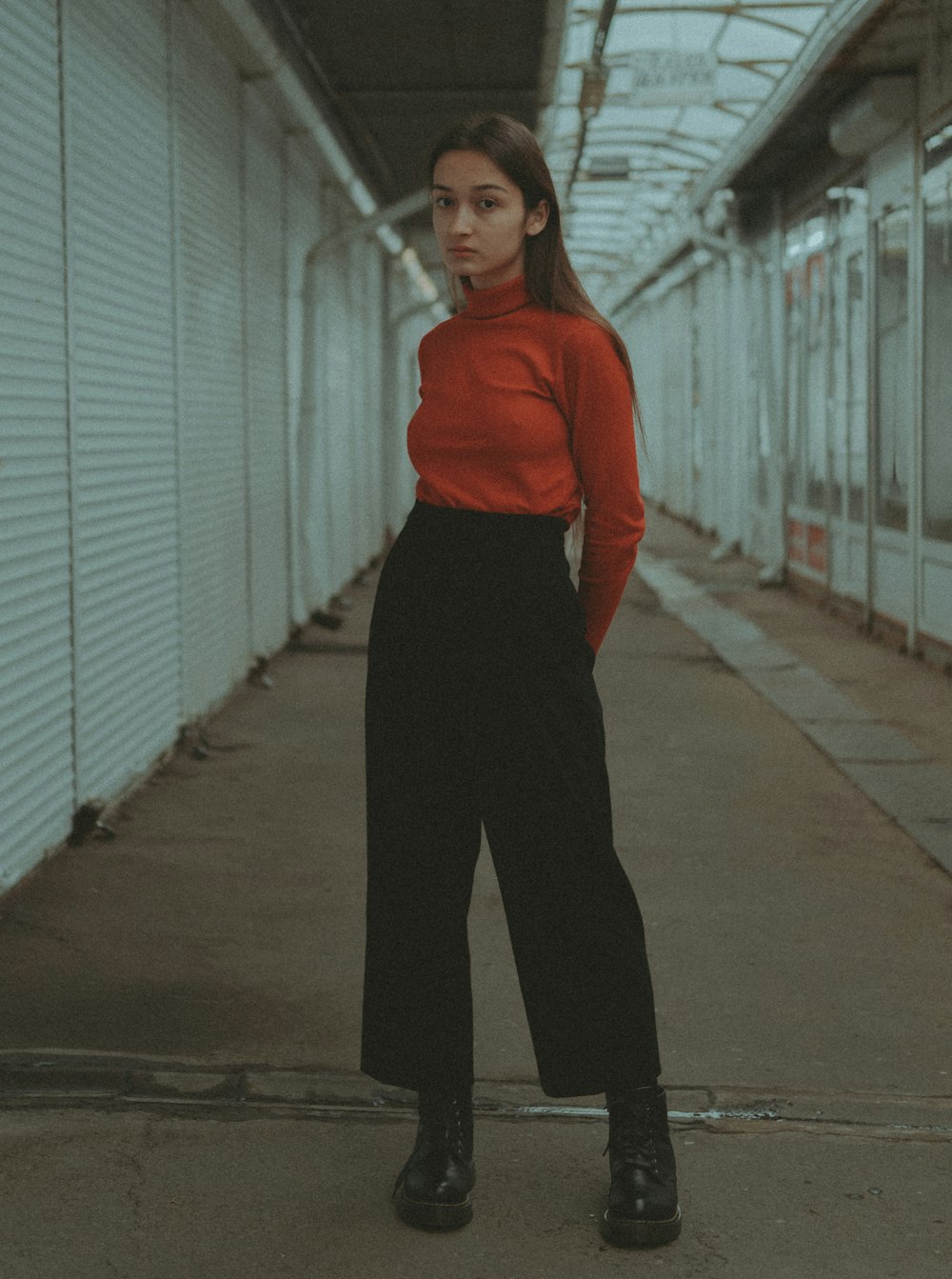 a woman in a red shirt and black pants