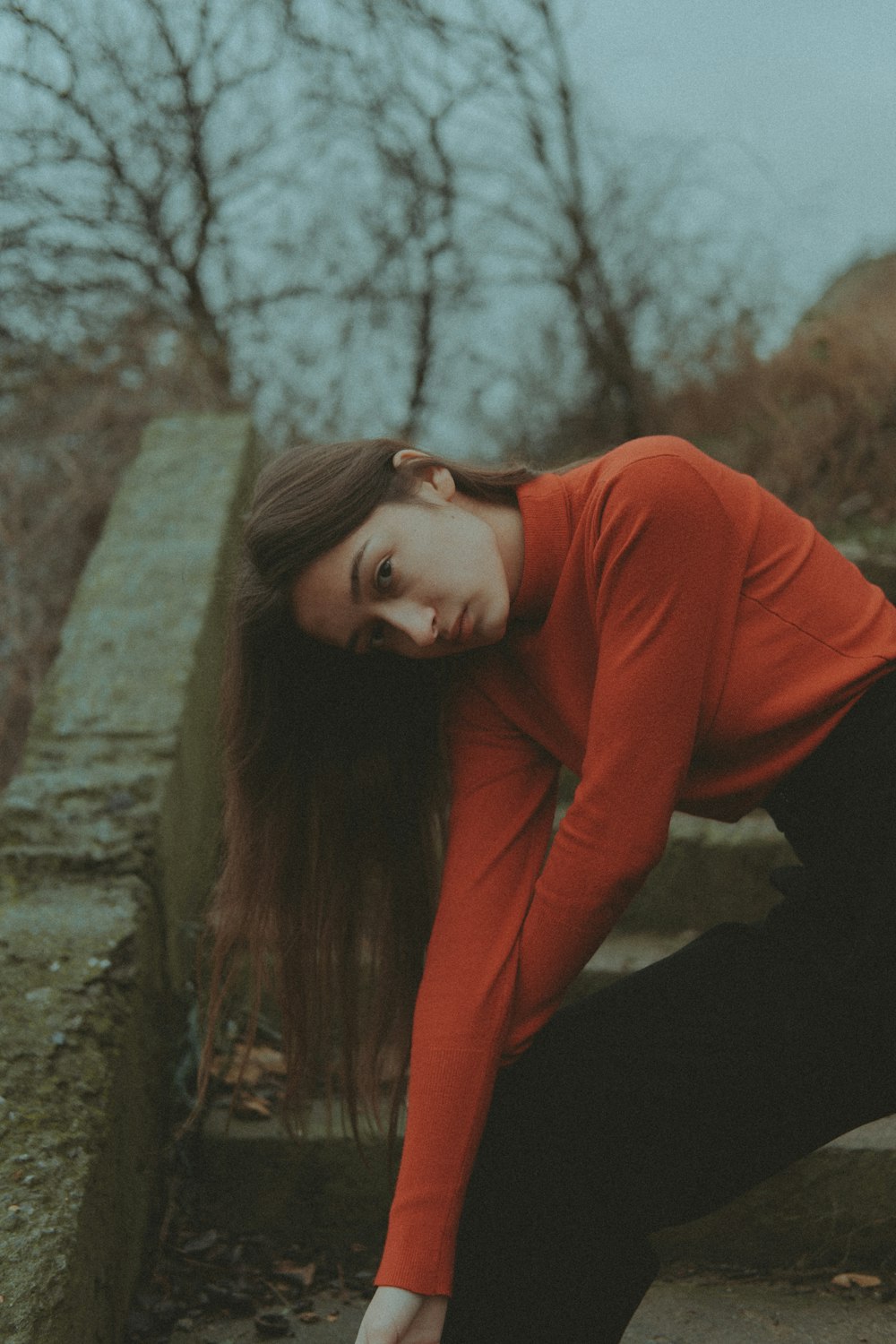 a woman in a red shirt and black pants