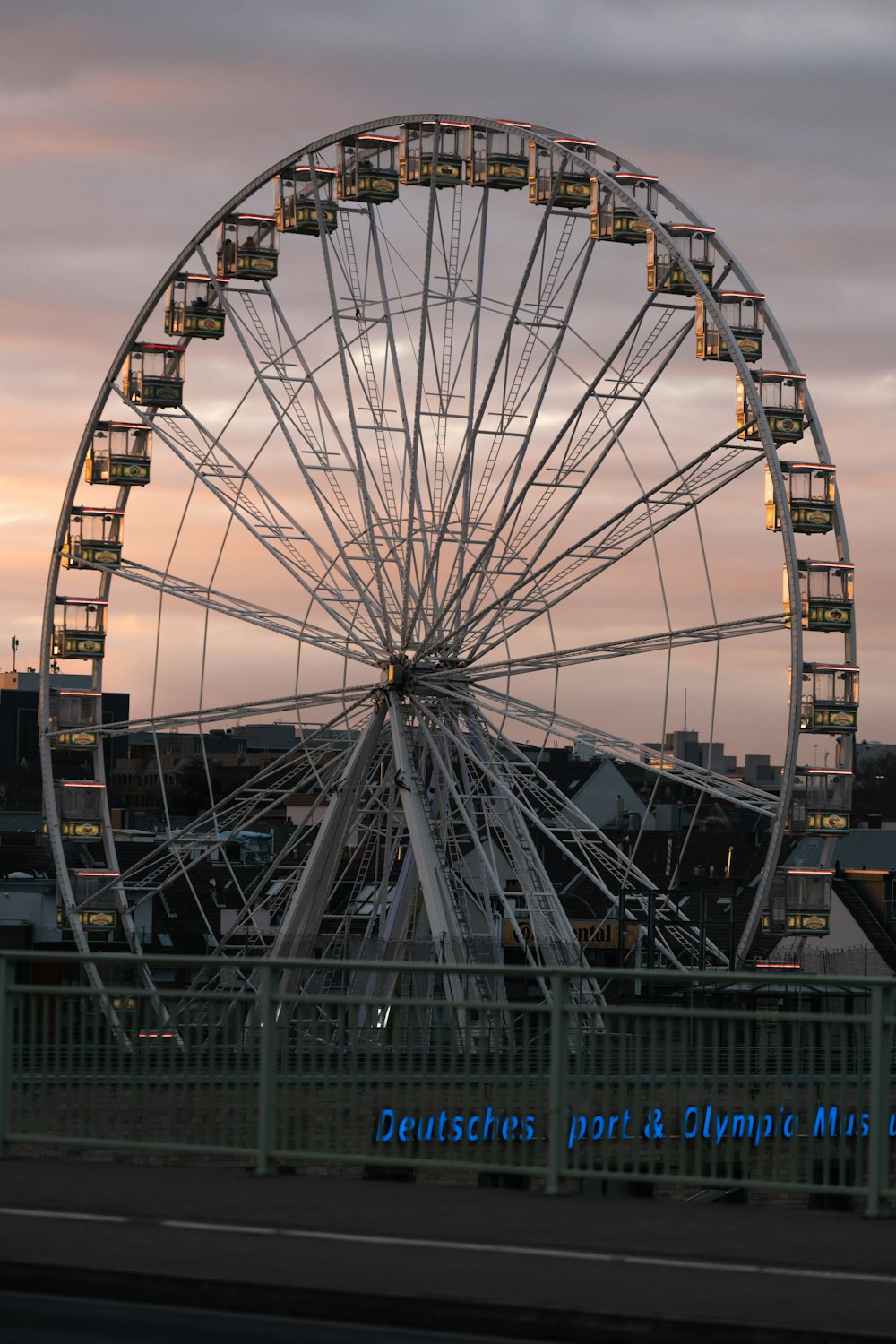 a large ferris wheel sitting on top of a bridge