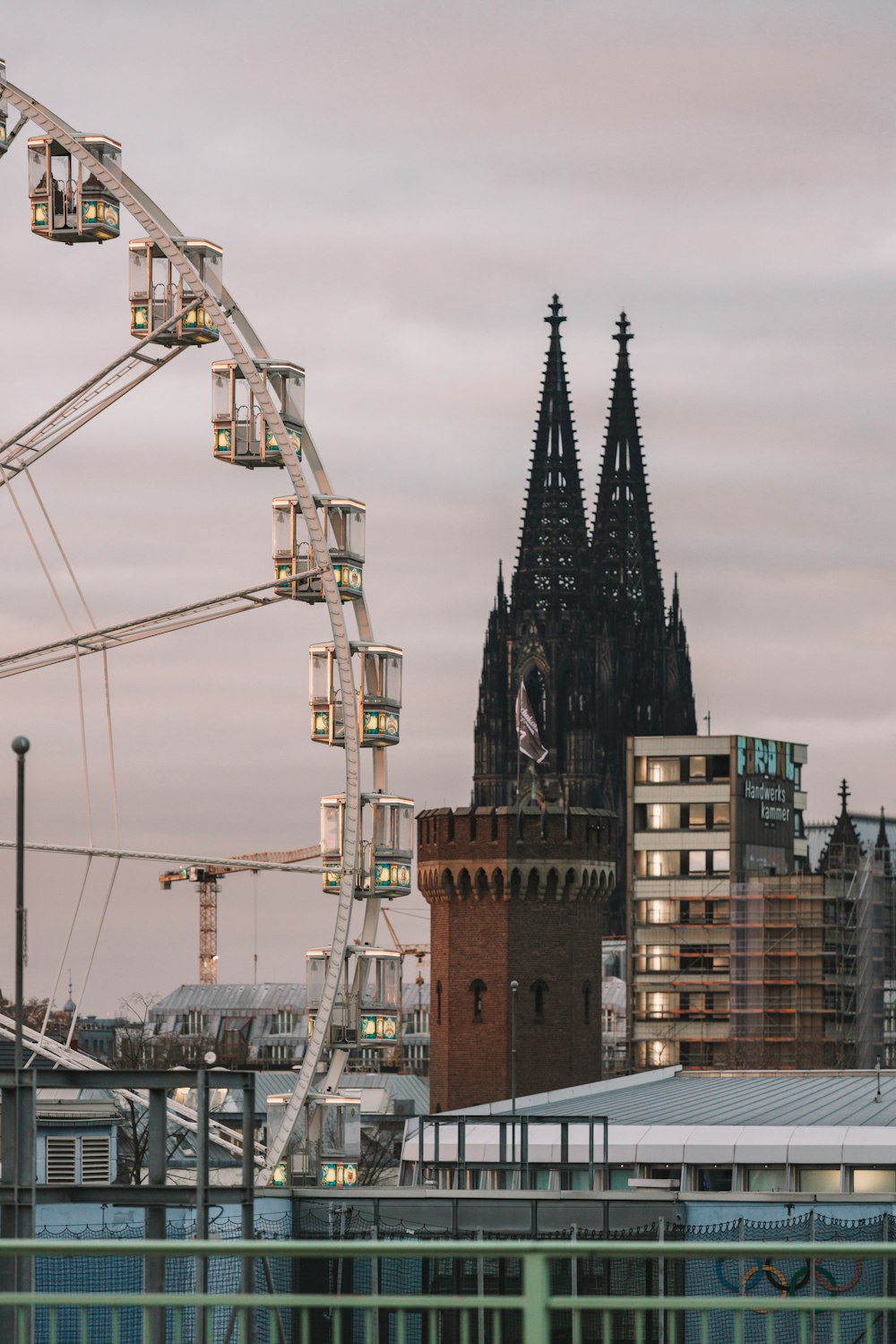 a ferris wheel in front of a tall building