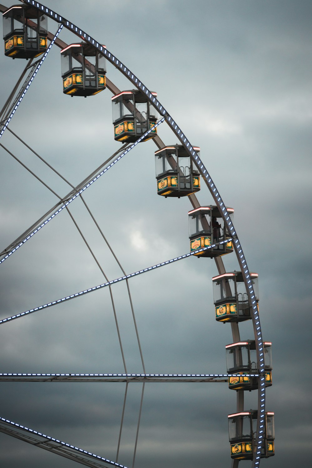a ferris wheel with a cloudy sky in the background
