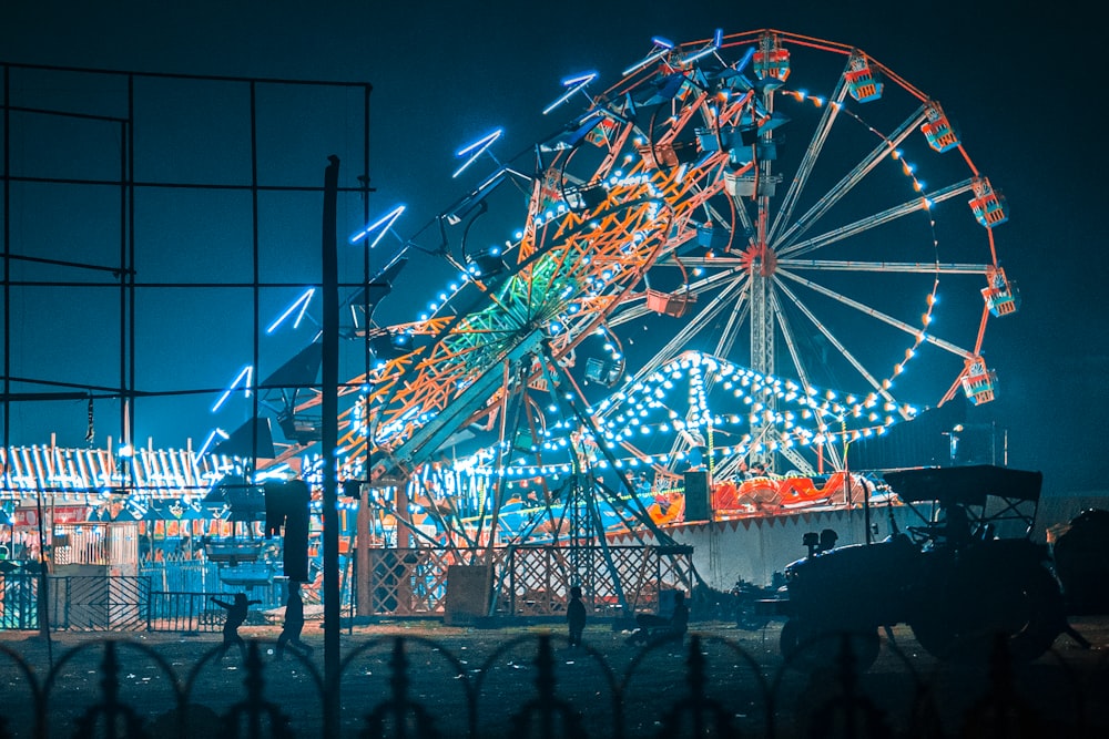 a ferris wheel is lit up at night