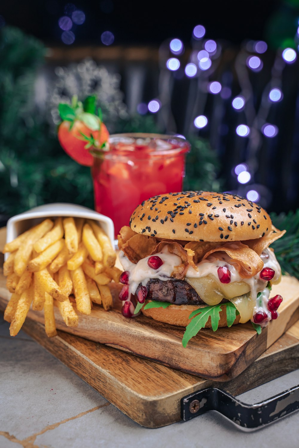 a cheeseburger and fries on a cutting board