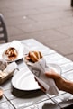 a person holding a napkin over a plate of food