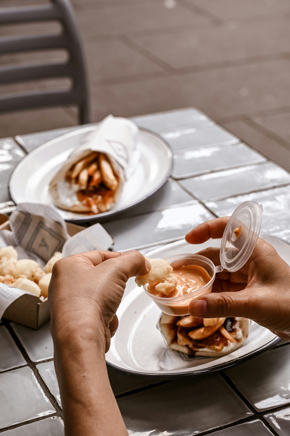 a person sitting at a table with a plate of food