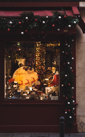 a store front with a christmas display in the window