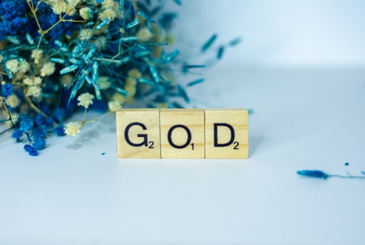 a wooden block with the word god written on it