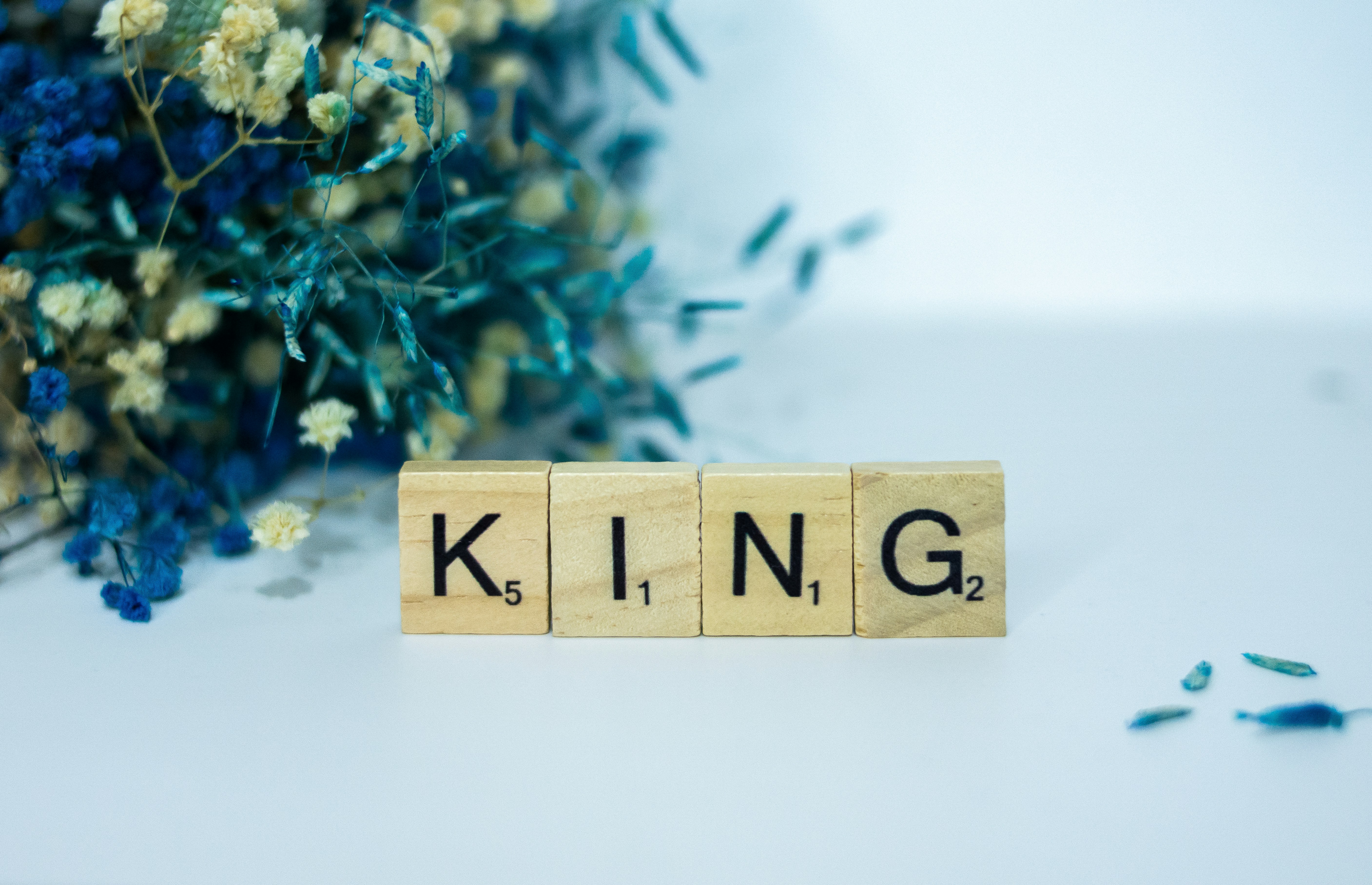 a scrabble type block spelling the word king