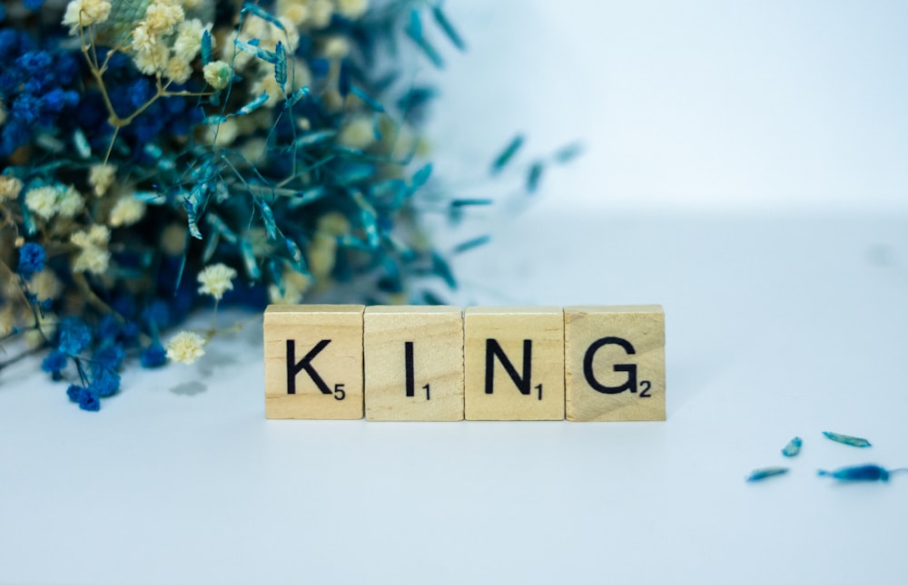 a scrabble type block spelling the word king