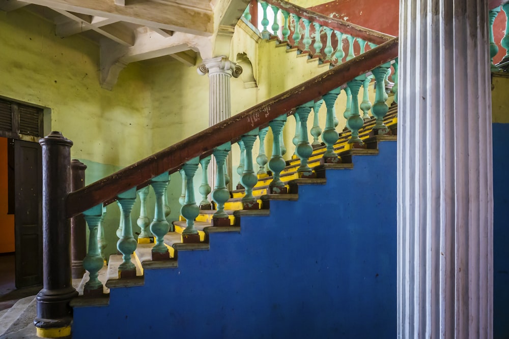 a blue and yellow staircase in a building