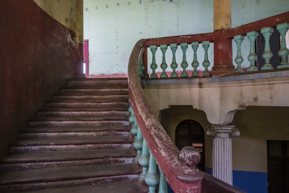 a staircase in an old building with railings and balconies