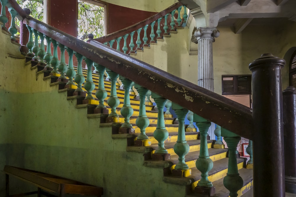 a green and yellow staircase in a building