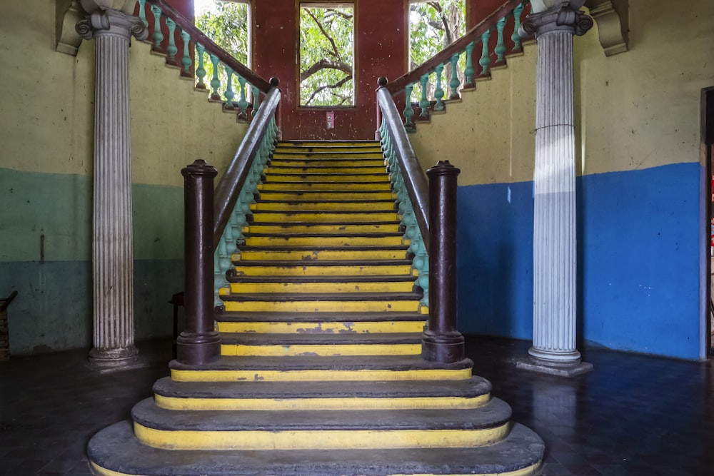 a set of yellow stairs leading up to a window