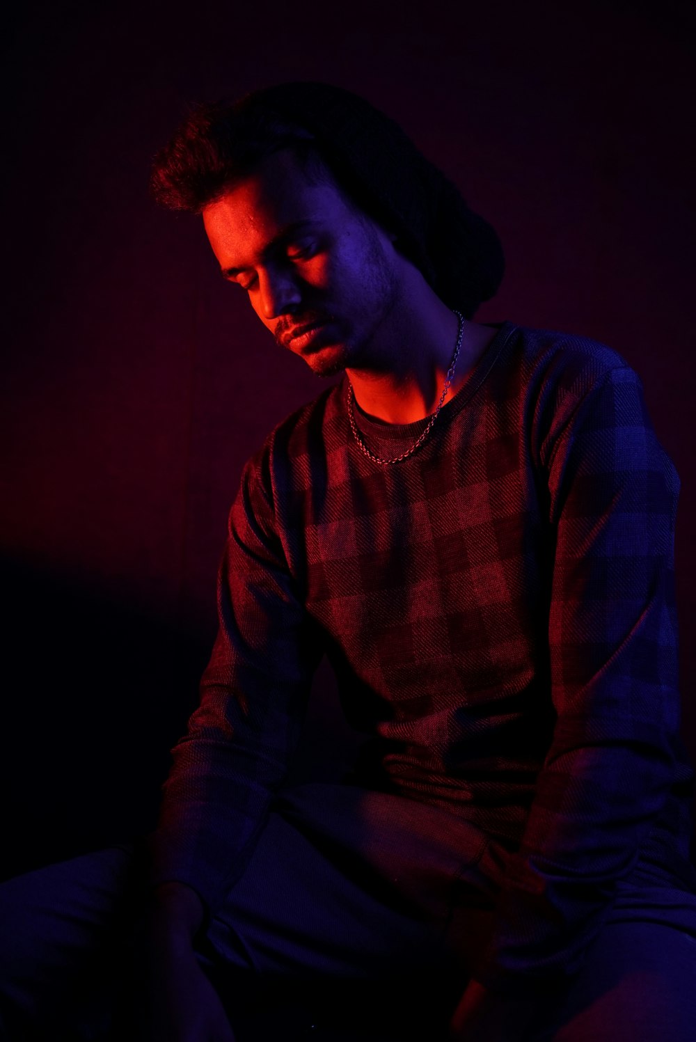 a man sitting down in a dark room