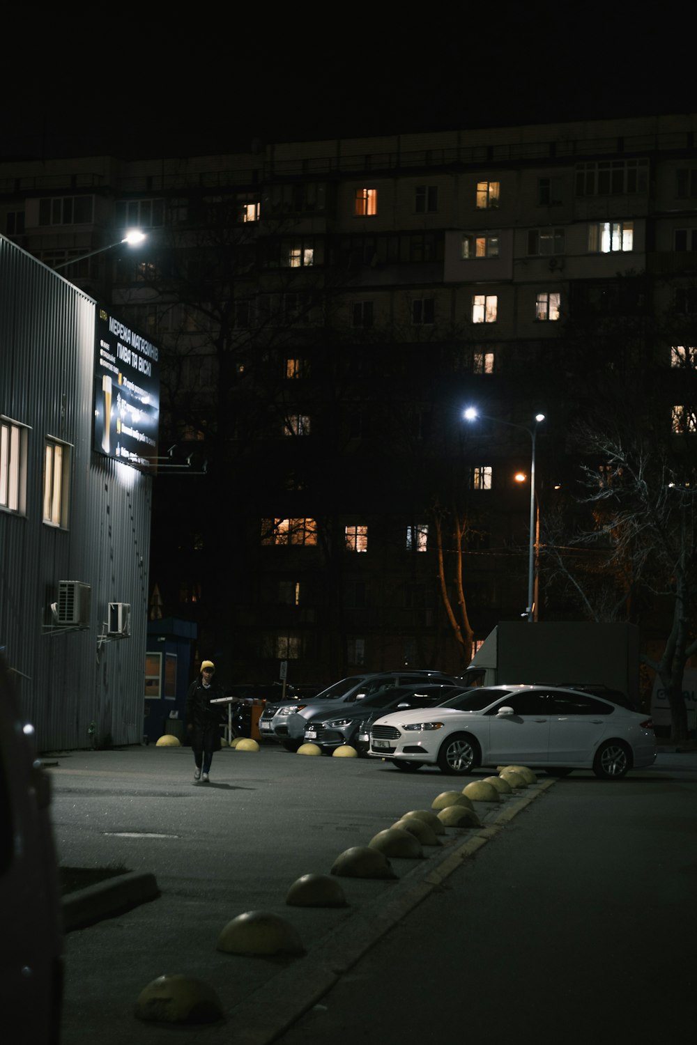 a person walking down a street at night