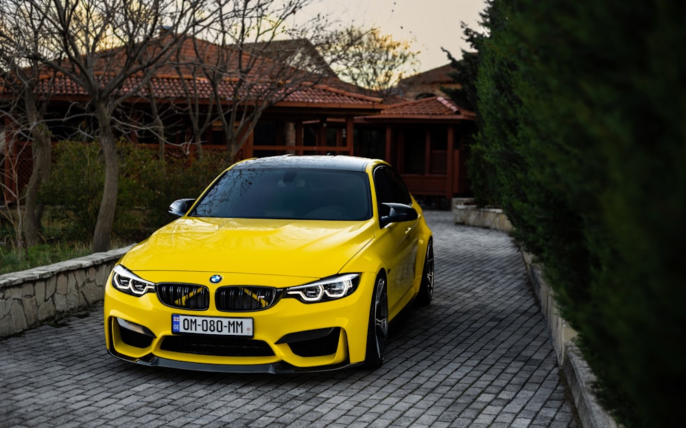 a yellow car parked in front of a house