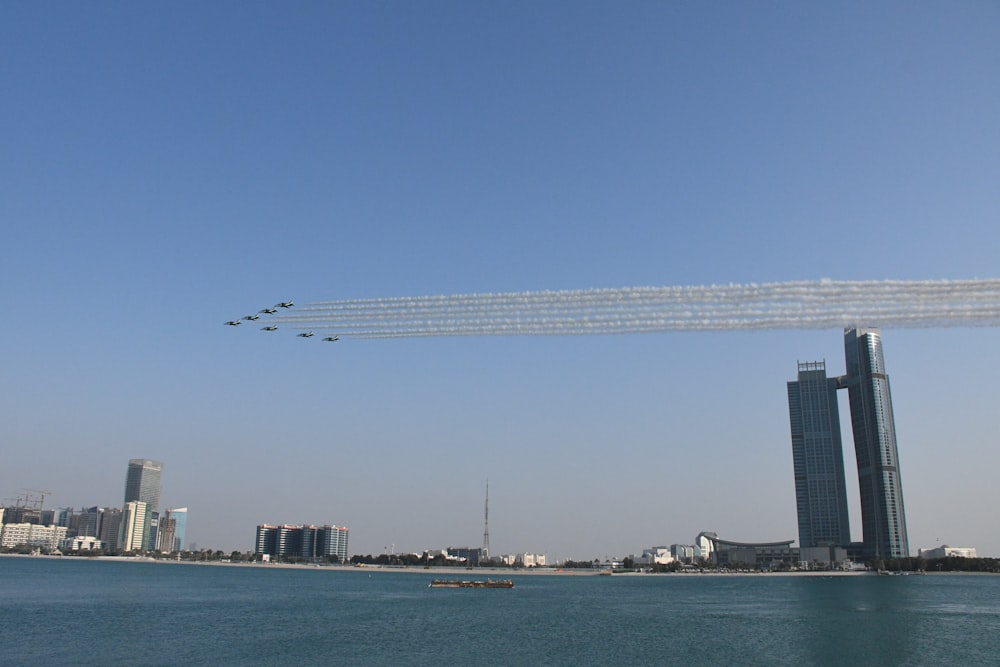 a group of airplanes flying over a body of water