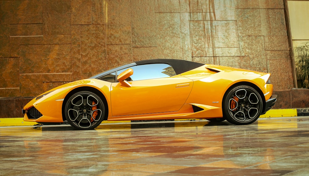 a yellow sports car parked in front of a building