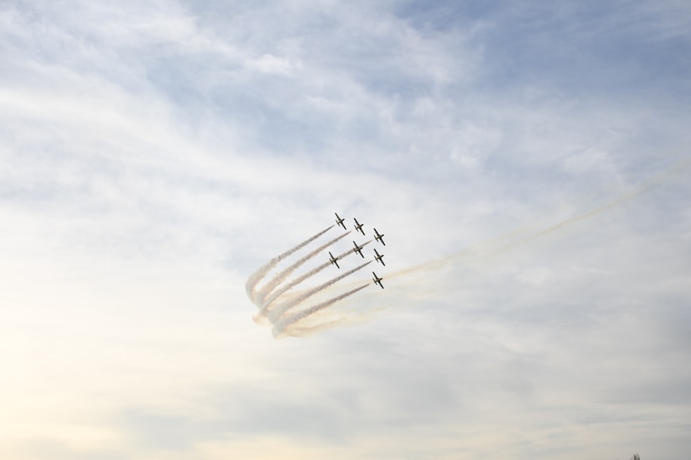 a group of airplanes flying through a cloudy sky