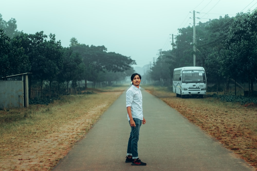 a man standing in the middle of a road